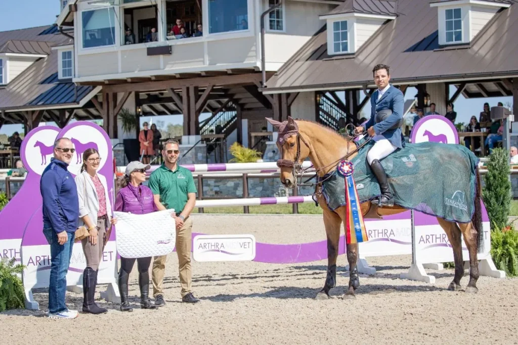 Daniel Bluman and Cachemire de Braize in the winners circle with TerraNova owners after the Arthramid Vet Grand Prix