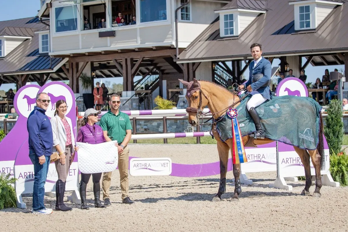Daniel Bluman and Cachemire de Braize in the winners circle with TerraNova owners after the Arthramid Vet Grand Prix