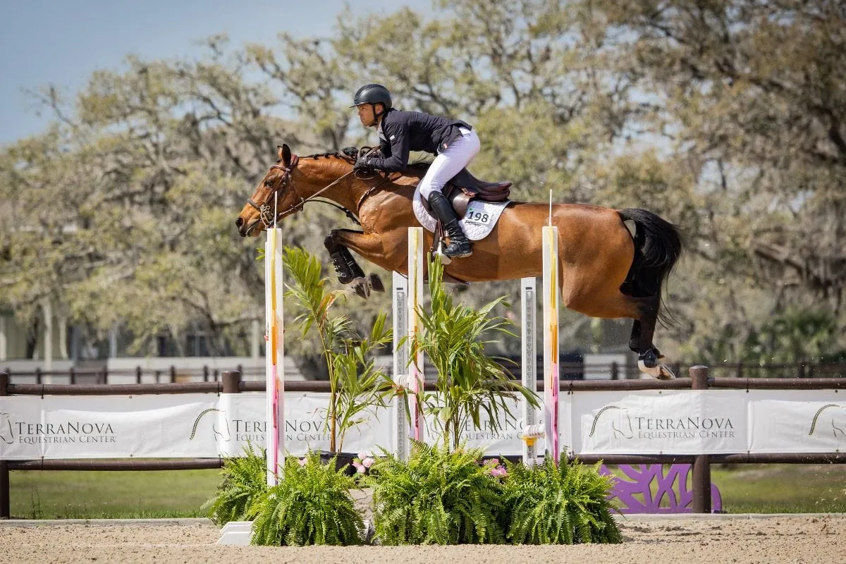 Kent Farrington and Dagny jumping the maximum-height triple bar in the FEI Grand Prix at TerraNova
