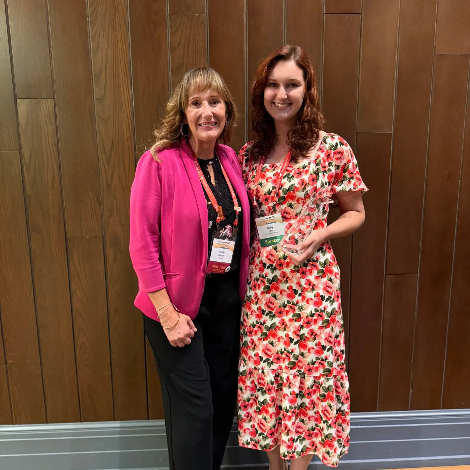 Molly Oakman and Ruby Tevis standing together as Tevis holds her AHP Equine Media NextGen Award