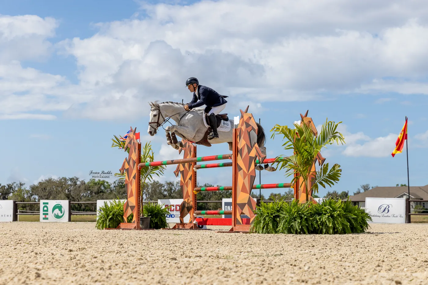 Samuel Parot riding the gray gelding Contigo Z over a jump to win the $75,000 B&D Builders National Standard Grand Prix