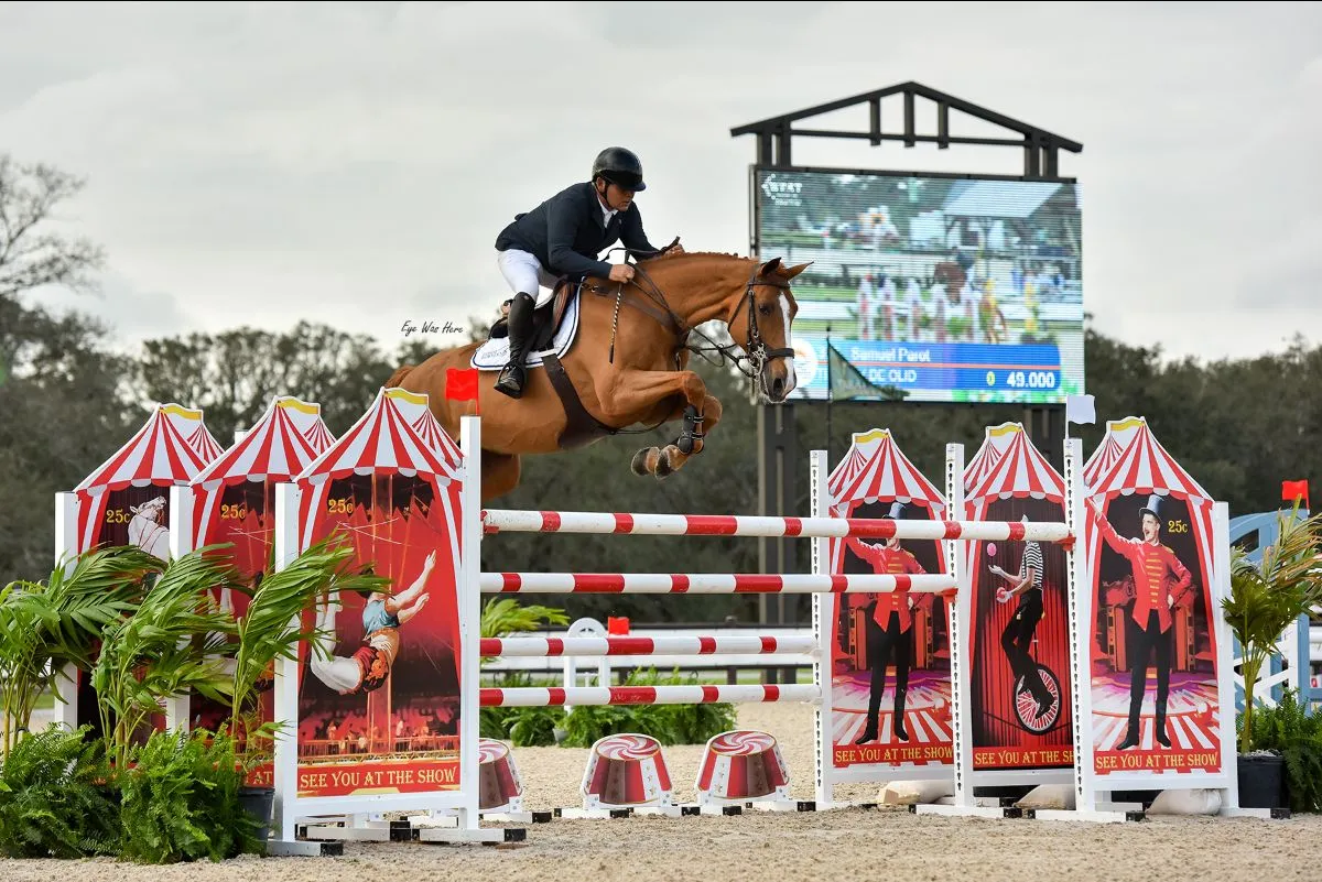 Samuel Parot riding Tiffany de Olid over the Big Top themed oxer at the Grand Prix of Sarasota at TerraNova