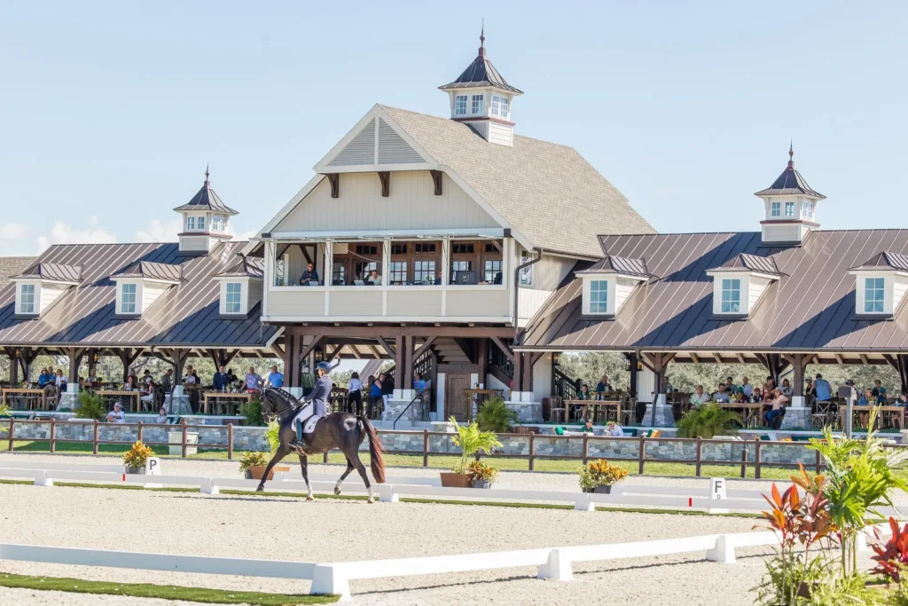 Dressage horse and rider performing in front of the grand pavilion filled with spectators at TerraNova Equestrian Center. Photo by EQ Media.