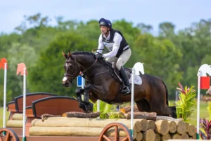Eventing rider jumping a cross-country log fence at TerraNova Equestrian Center