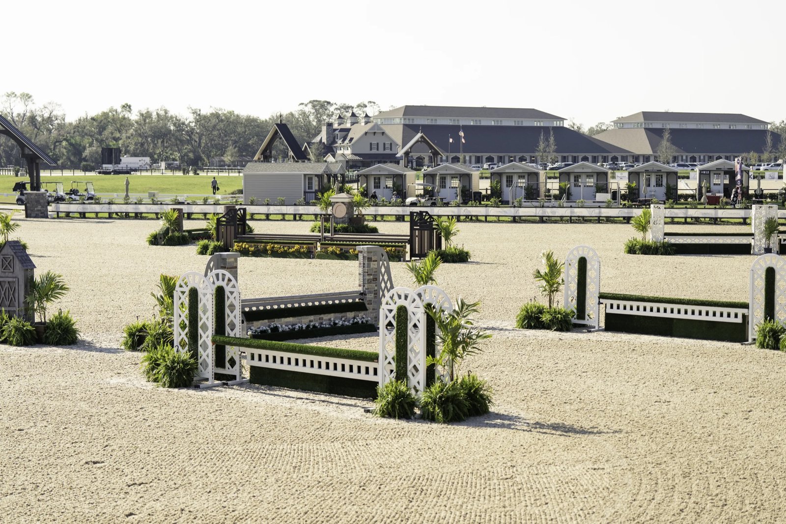 Show jumping arena with vendor cottages and stabling at TerraNova Equestrian Center
