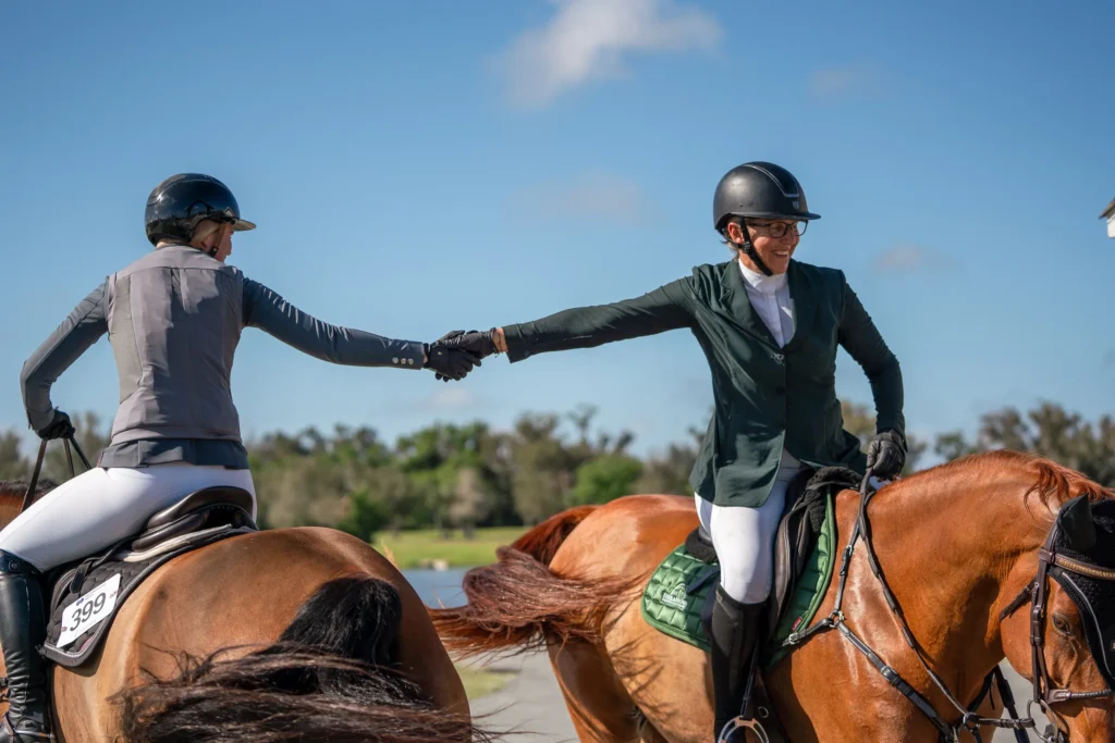 Two competitors on horseback shake hands after a class at TerraNova Equestrian Center