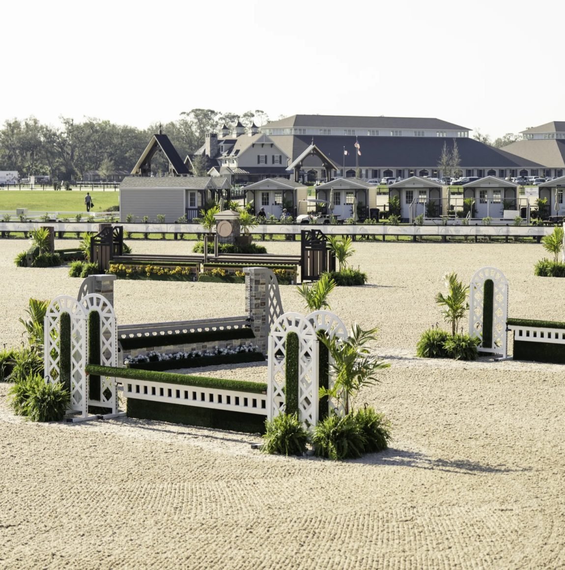 Show jumping arena with vendor cottages and stabling at TerraNova Equestrian Center
